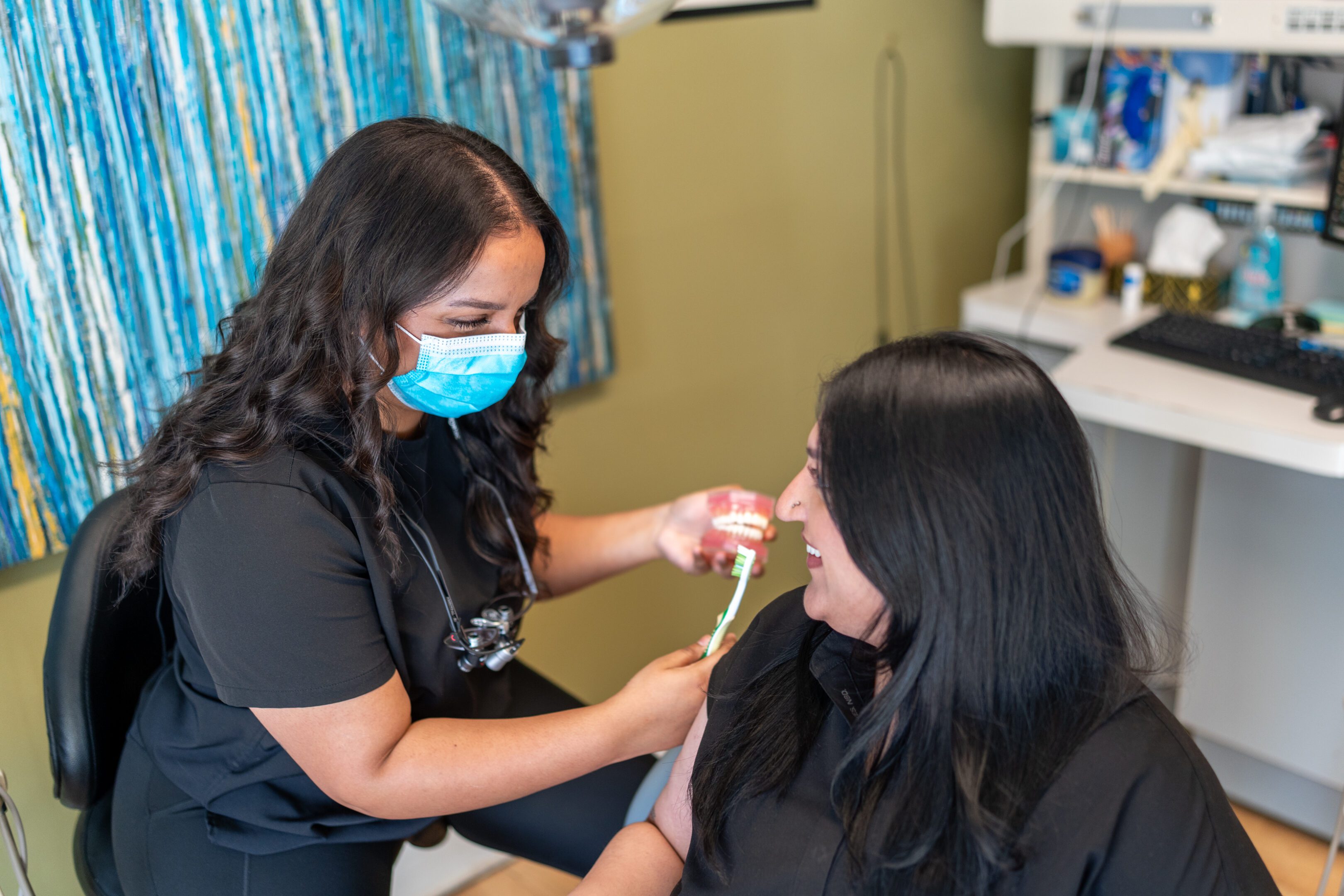 Dentist demonstrating dental care to patient.
