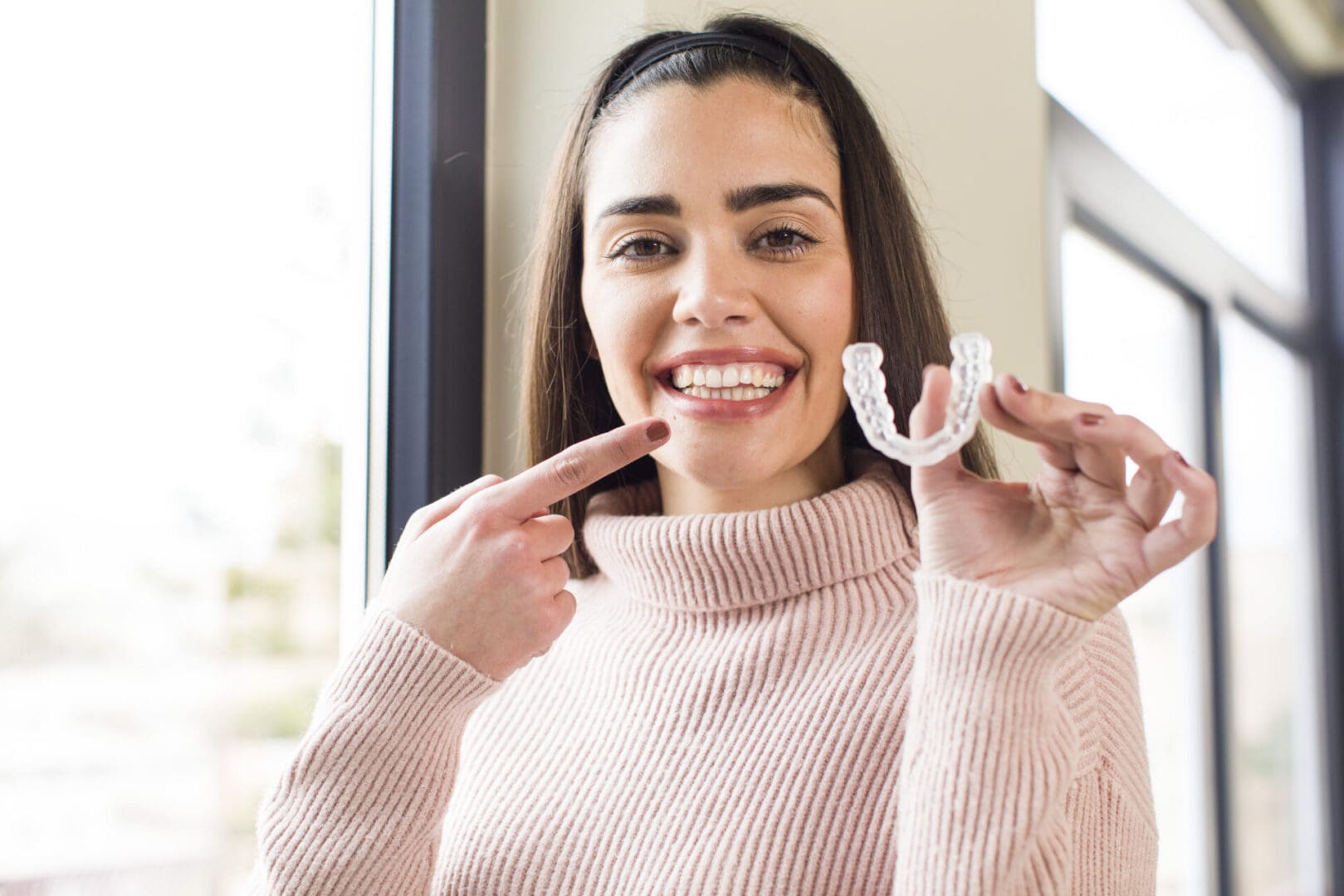 pretty young woman with a dental retainer. house interior design